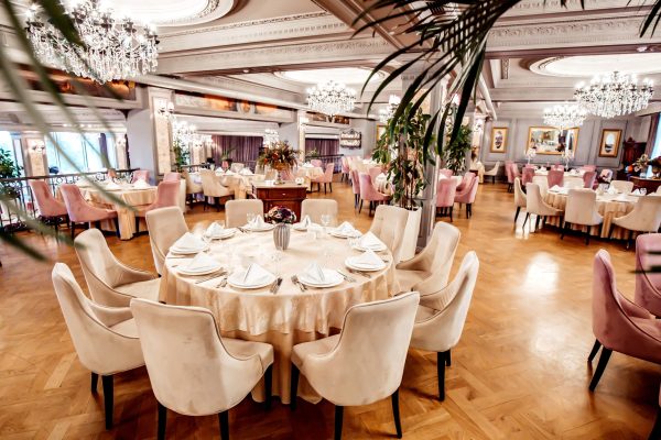 restaurant-hall-with-round-square-tables-some-chairs-plants-min